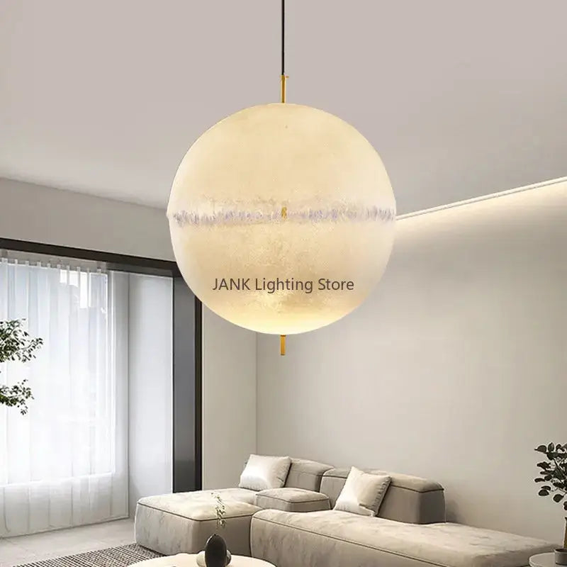 A warm off-white textured designer moon pendant chandelier with gold hardware for modern living room decorbites designer moon lighting