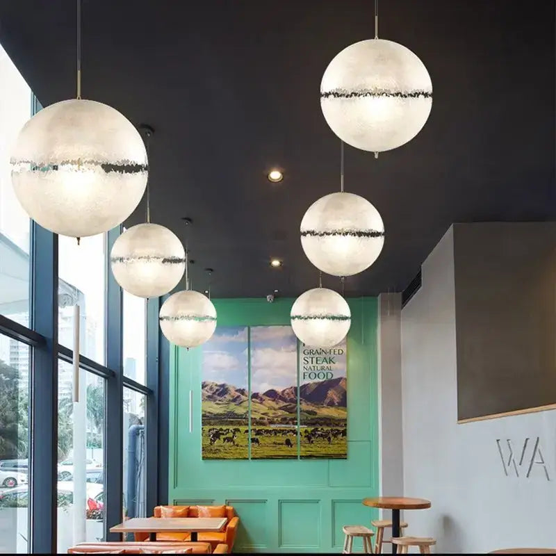 Modern textured moon pendant chandelier with white frosted glass and black bands as a decorbites designer moon pendant