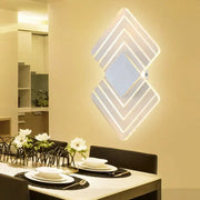 Modern textured silver and black direct wired electric wall sconce with layered diamond-shaped led lighting for bedroom