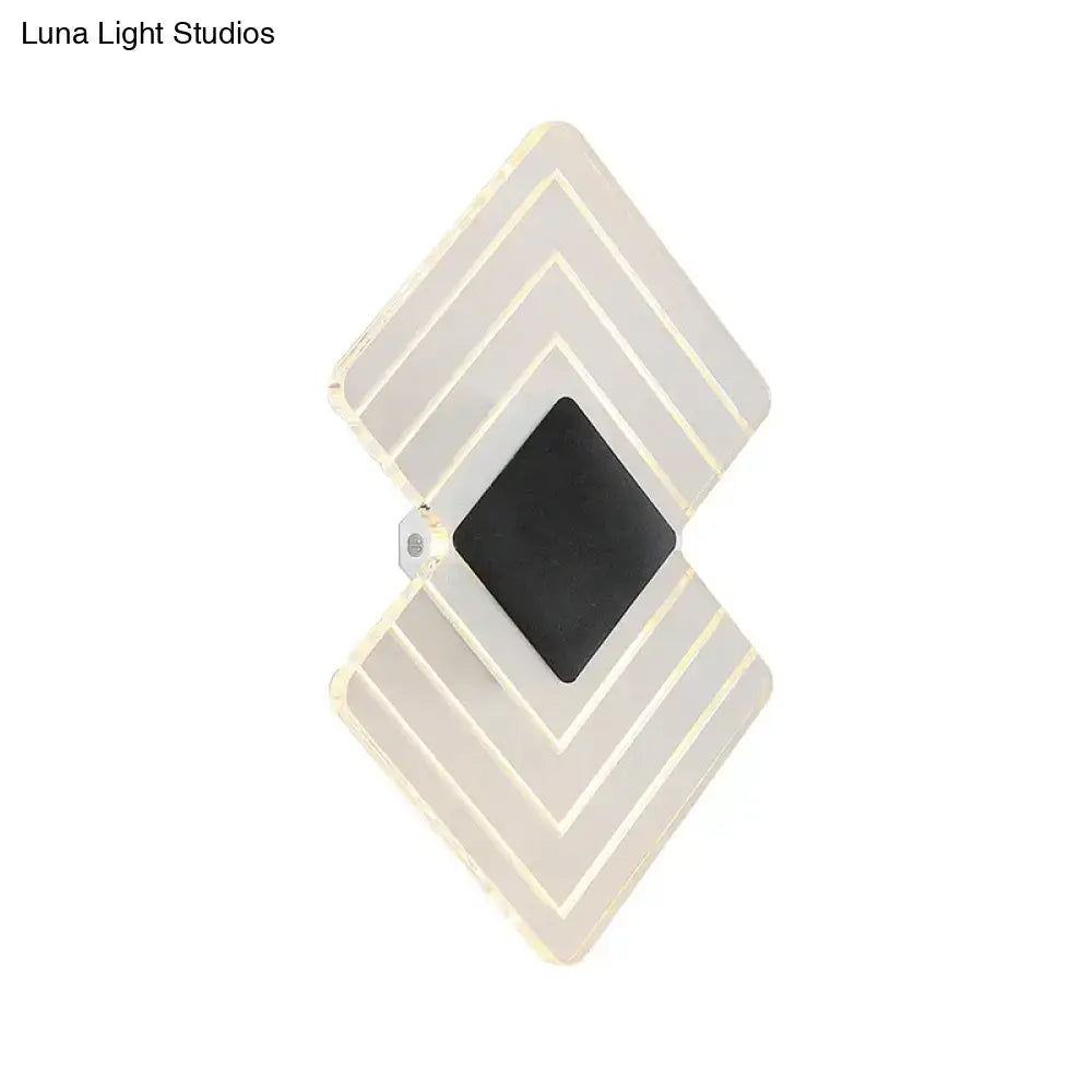 Modern textured silver and black direct wired electric led wall sconce with diamond-shaped layered translucent panels