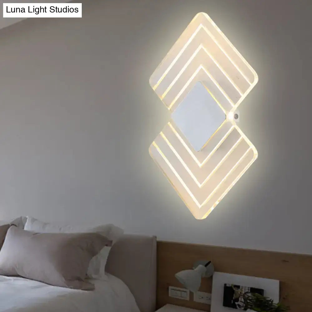 Modern textured silver and black direct wired led wall sconce with layered diamond-shaped warm white lighting