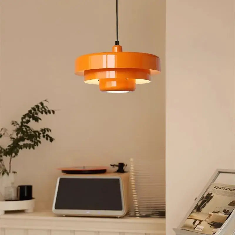 Modern tiered pendant light with vibrant orange glossy finish and layered design for dining room decorbites dark green