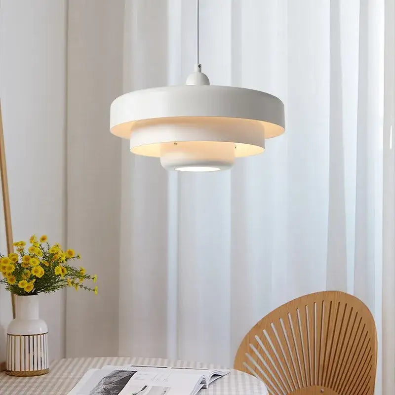 Modern tiered pendant light in dark green with concentric rings and warm glow for dining room decorbites dark green