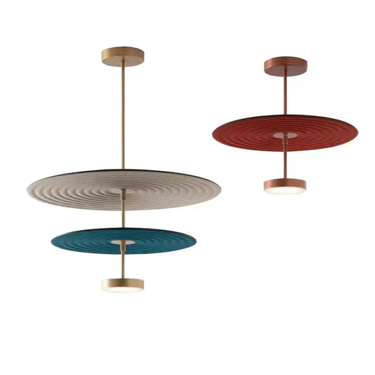 Modern tiered pendant lights with concentric cotton round led patterns in beige teal and terracotta on brass frames