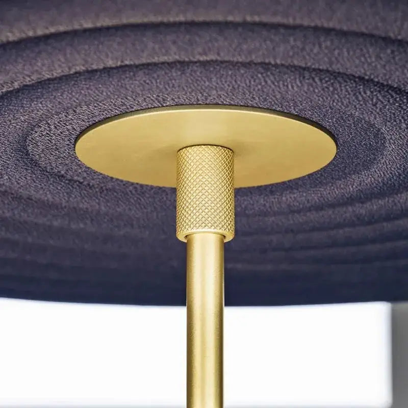 Modern tiered cotton round led pendant lights featuring a gold-toned metal fixture with a textured base and ribbed stem