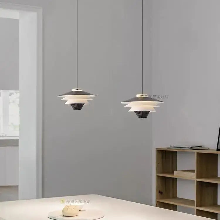 Modern black and white layered pendant lights with sleek minimalist design featuring cream wind milk glass for kitchen dining