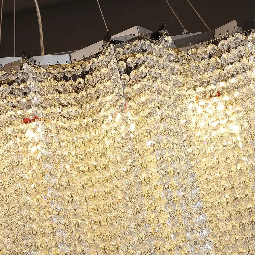 A modern tiered decorbites colorful crystal chandelier with cascading clear glass orbs for staircase decor