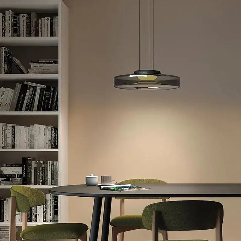 Modern tiered glass pendant light with translucent dark gray decorbites bohemia glass and glowing yellow illumination for kitchen island