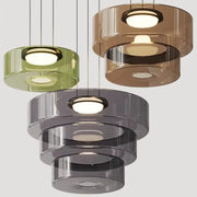 Modern tiered pendant light with translucent green amber and gray glass featuring circular illuminated centers by decorbites bohemia glass