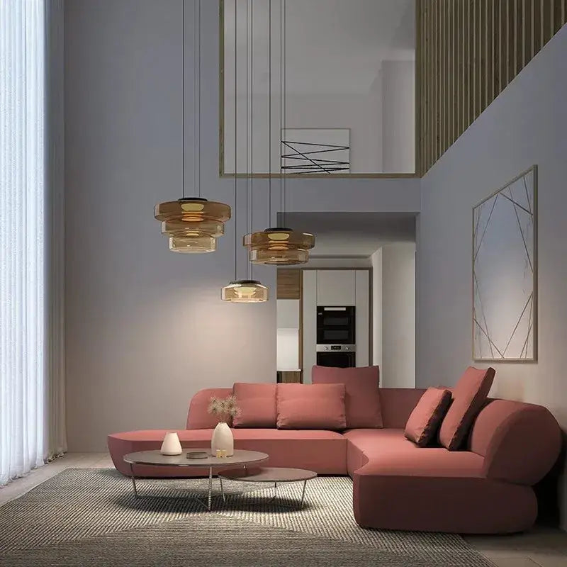 Modern blush pink sectional sofa with curved design and plush cushions paired with decorbites bohemia glass pendant light