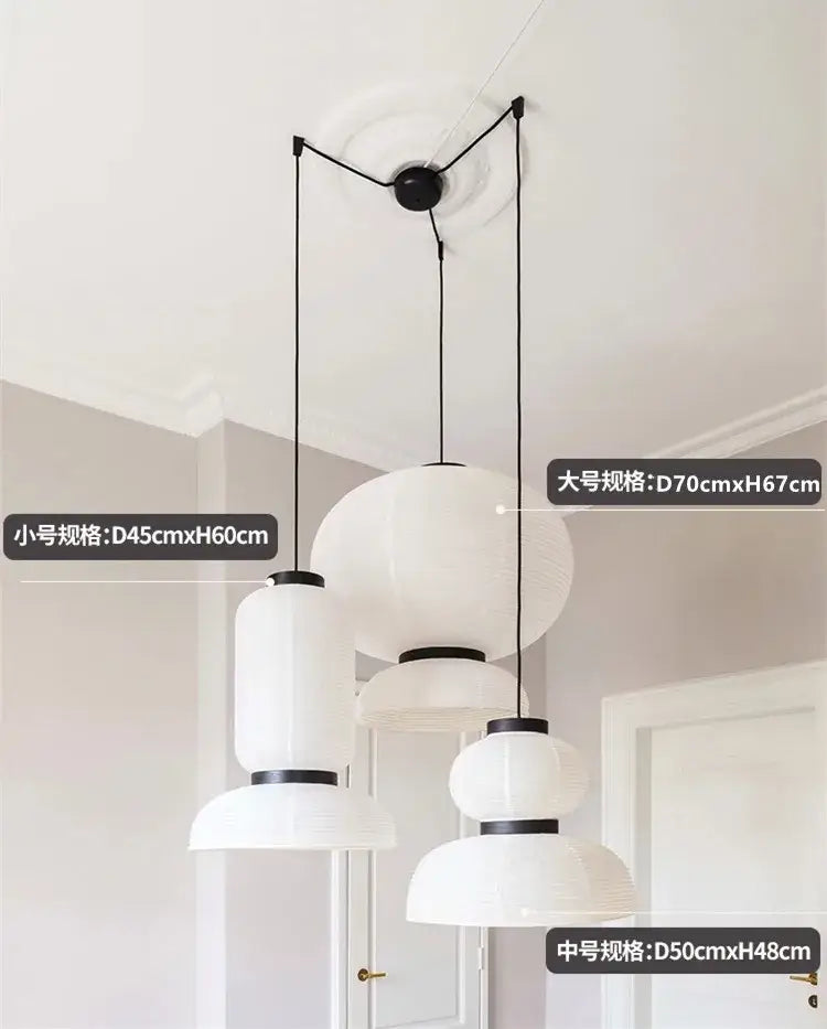 Modern tiered off-white paper pendant lights with black metal accents and spherical shapes for dining room decorbites designer led