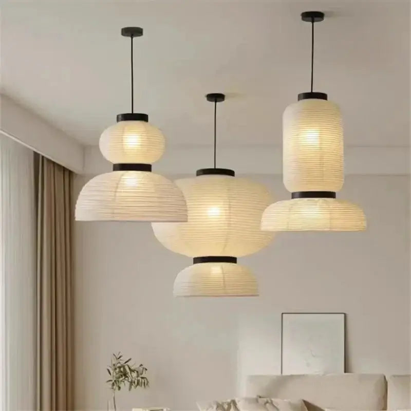 Three elegant off-white tiered paper pendant lights with black metal accents by decorbites designer led for dining room decor