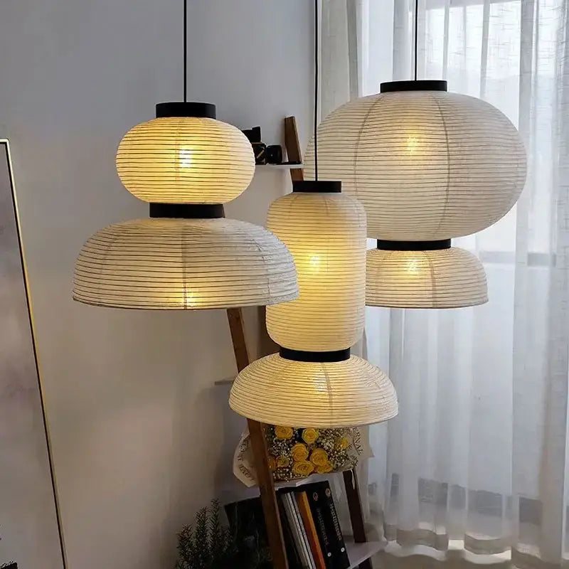 Warmly glowing modern tiered off-white paper pendant lights with subtle ribbing for dining room decorbites designer led