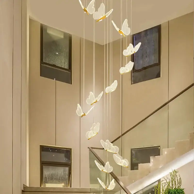 A delicate white butterfly staircase pendant light with gold accents for modern stairwell decorbites pendant lights