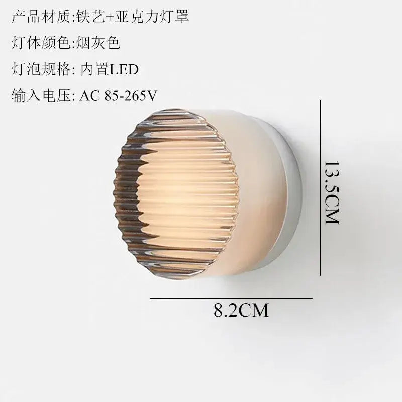 A sleek smoke-gray wall lamp with ribbed acrylic dimple potato chip shade and iron frame for bedroom lighting