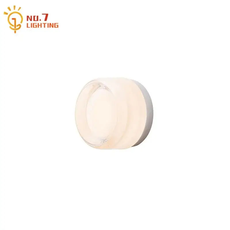 Minimalist dimple potato chip wall lamp with frosted glass diffuser and metallic base by no.7 lighting for bedroom use