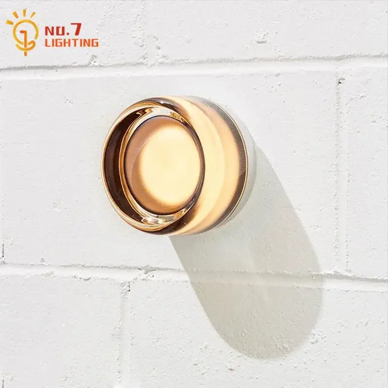 Glossy gold circular dimple potato chip wall lamp with modern minimalist design for bedroom lighting