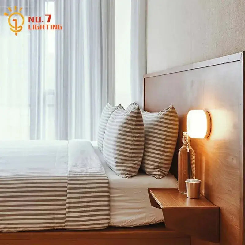 Warm-toned modern translucent dimple potato chip wall lamp with circular glass design for bedroom lighting