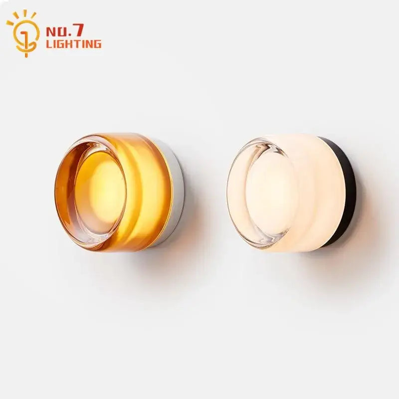 Two modern wall lamp dimple potato chip sconces by no.7 lighting with amber and off-white translucent glass shades
