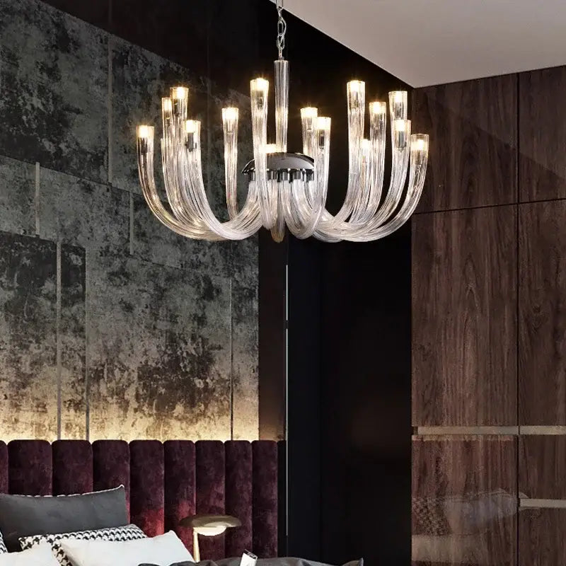 A modern transparent glass chandelier led with clear curved glass arms and chrome fixture for dining room lighting
