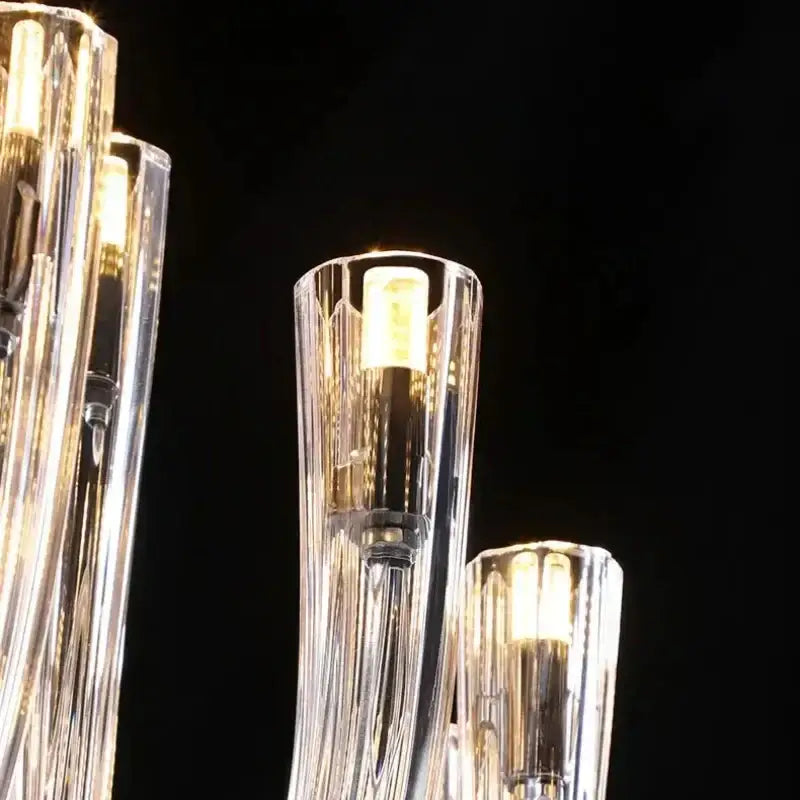 Modern transparent glass chandelier led hanging light with clear faceted arms and warm glowing bulbs for dining room