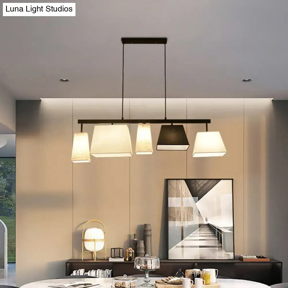 Modern black metal hanging lamp with five off-white and dark gray rectangular fabric shades for island light use