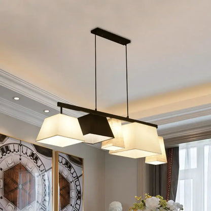 Modern black metal hanging lamp with three off-white trapezoid fabric shades for island light or ceiling light use