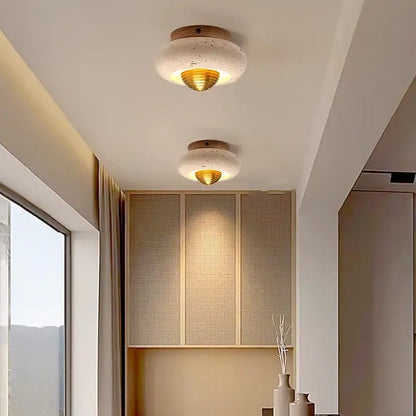 Modern travertine and walnut decorbites led ceiling lamp with textured white concrete disc and gold-toned diffuser for bedroom light