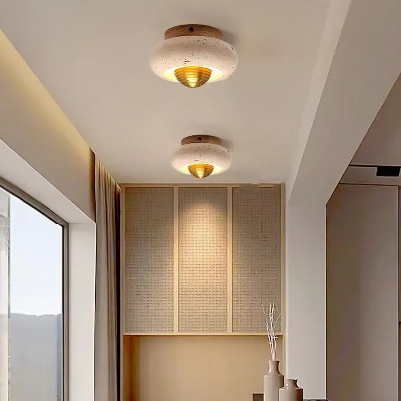 Modern travertine and walnut decorbites led ceiling lamp with textured white concrete disc and gold-toned diffuser for bedroom light