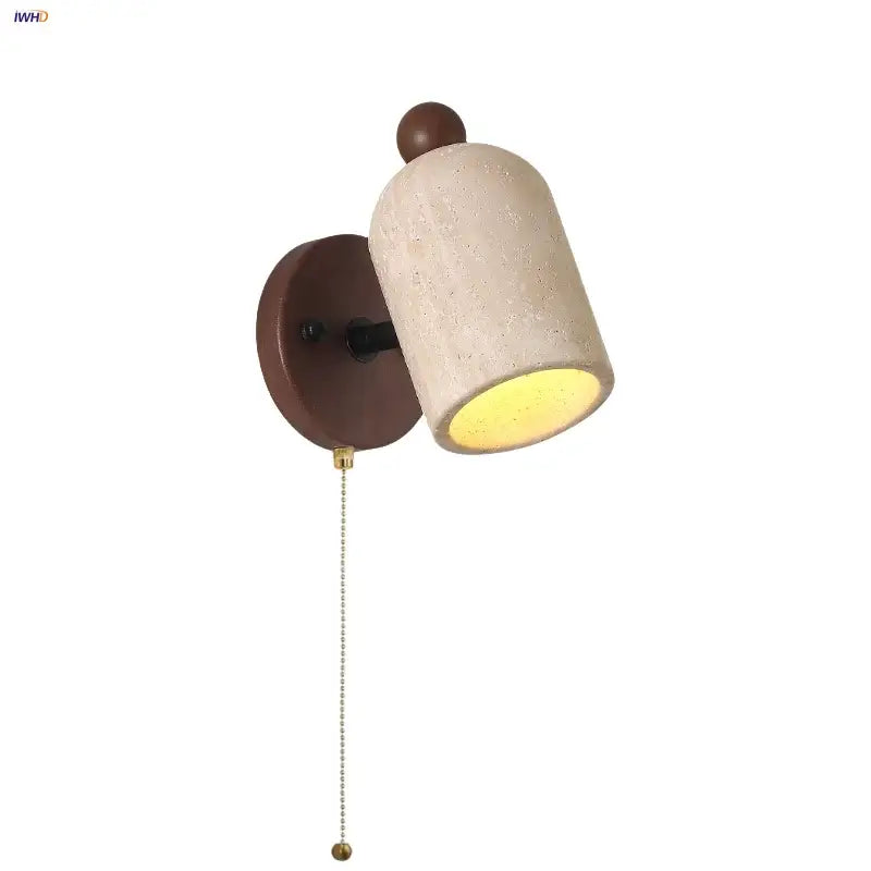 Beige travertine and wood wall light fixture with a dark brown backplate and pull chain switch for bedroom use