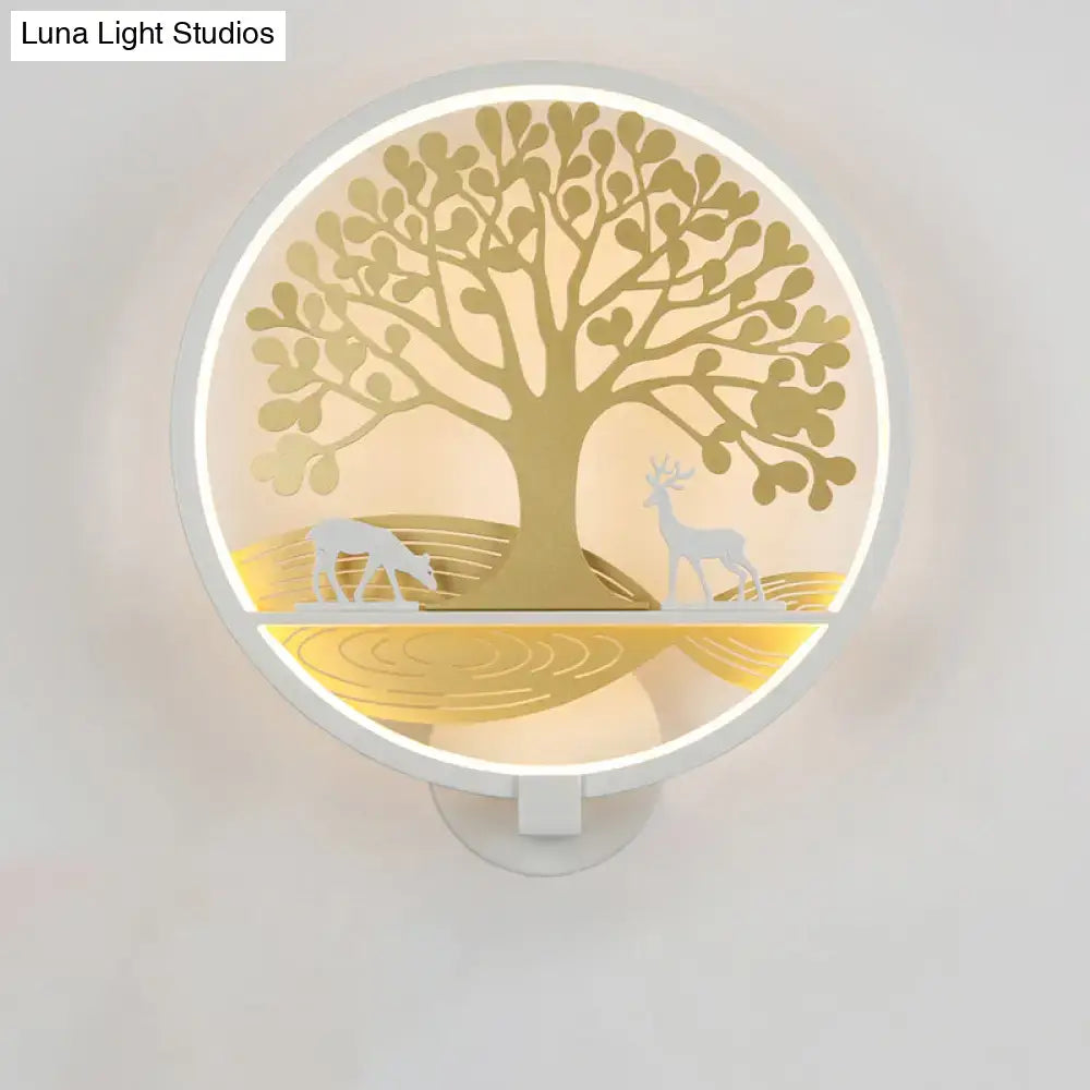 Modern wall lamp featuring a circular golden tree of life design with deer silhouettes and white frame for bedroom use