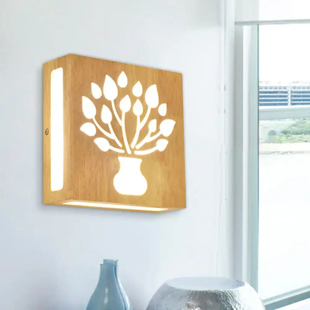 Square wooden wall light with carved tree-in-vase design in bamboo, emitting warm light, direct wired electric with max bulb wattage