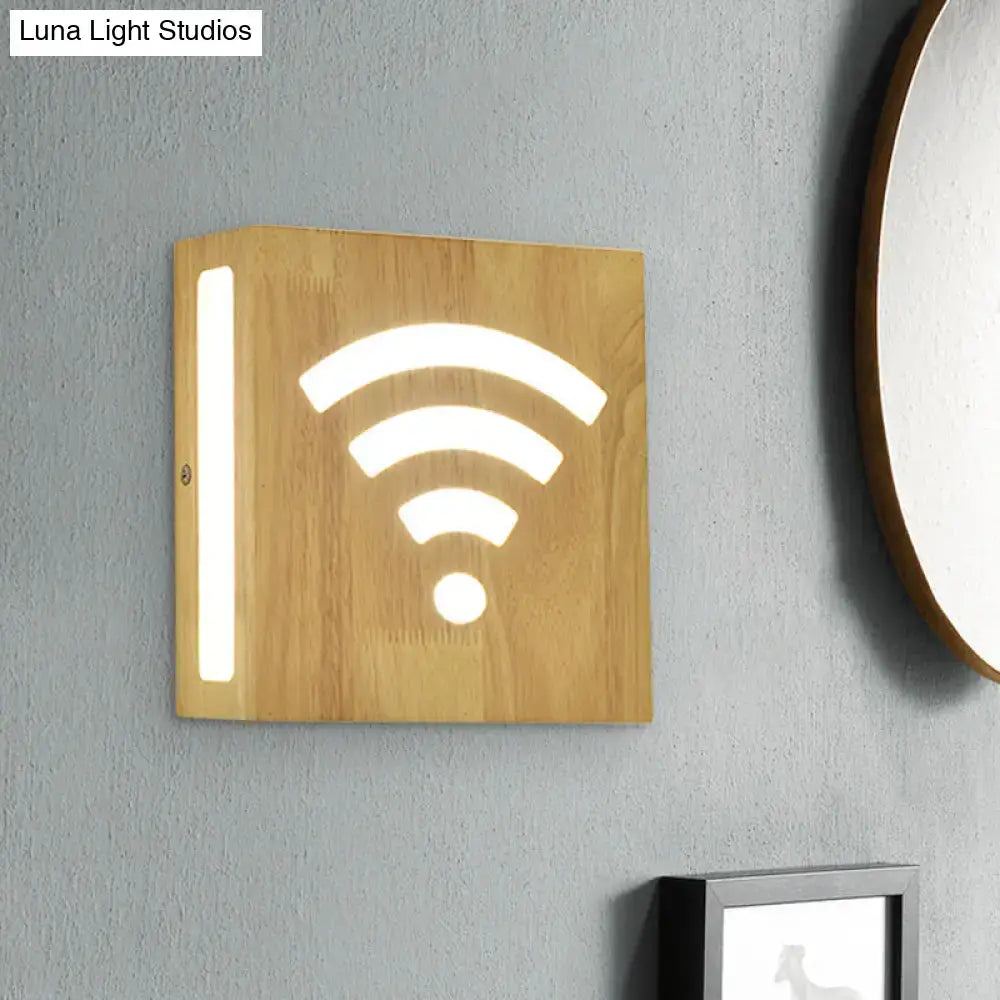 Modern tree pattern bamboo wall light with light wood finish and illuminated white wi-fi symbol direct wired electric
