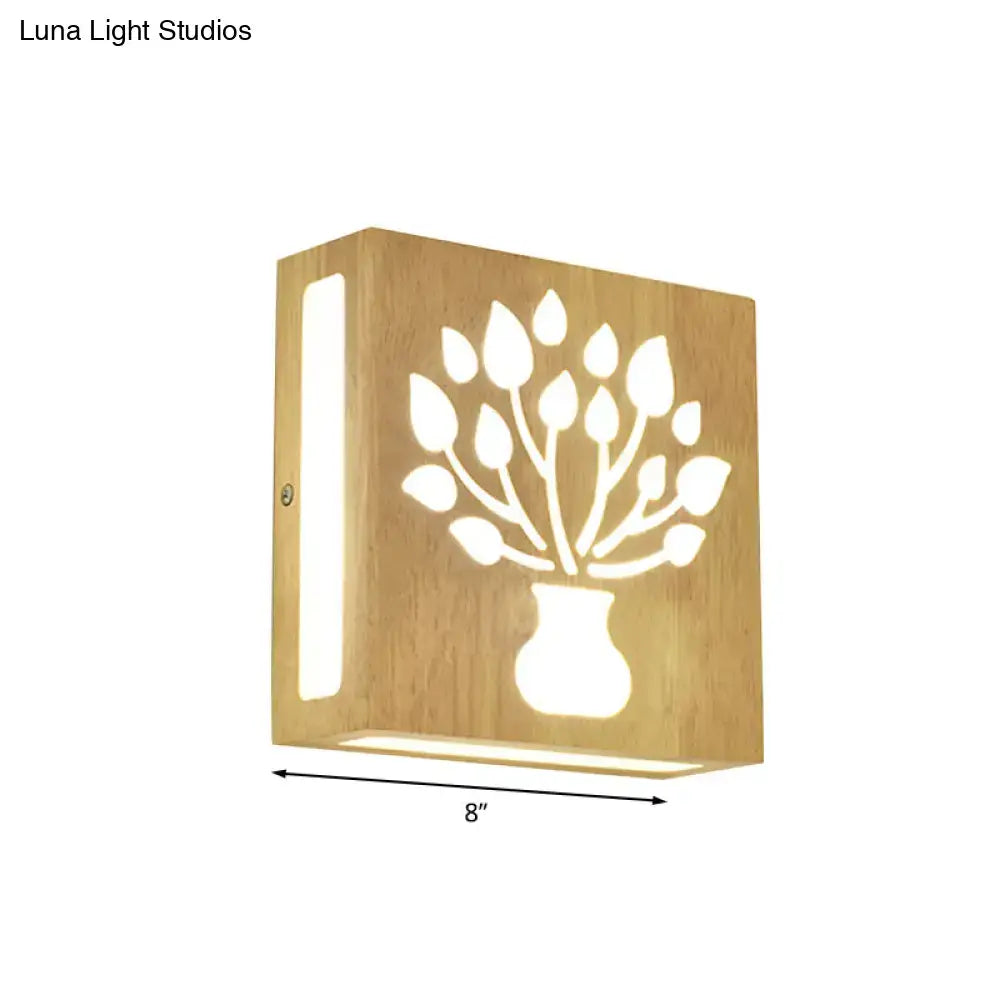 A warm-toned bamboo wall light with a tree silhouette cutout, direct wired electric for bedroom use and maximum bulb wattage