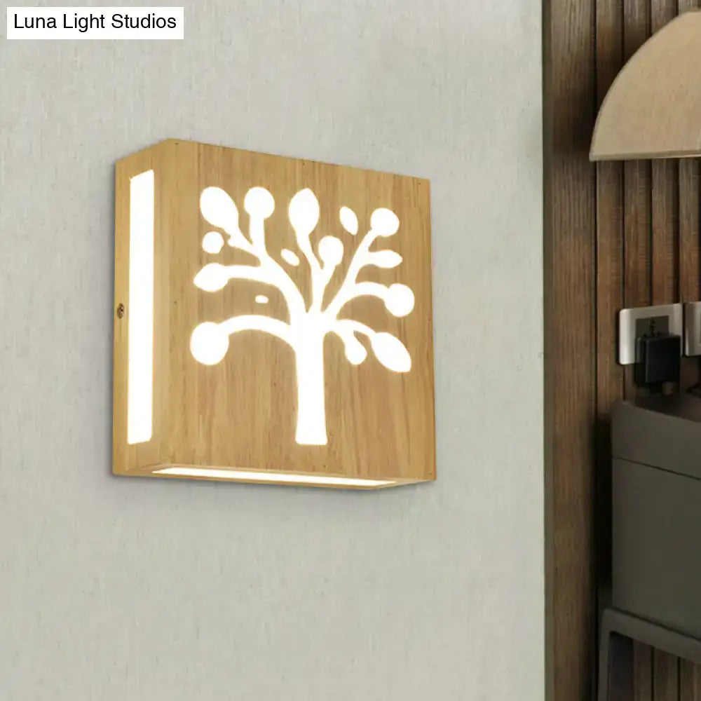 A square wooden wall light with carved tree design made of bamboo, direct wired electric, emitting warm light