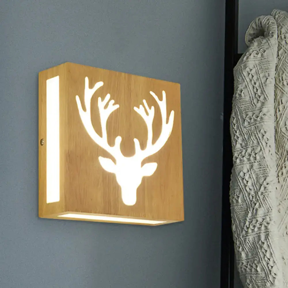 A square bamboo wall light with a deer head cutout design emitting warm light for direct wired electric use