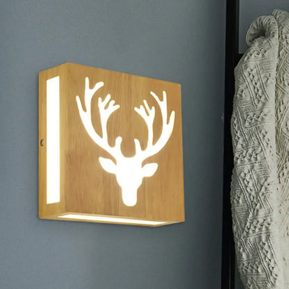 A square bamboo wall light with a deer head cutout design emitting warm light for direct wired electric use
