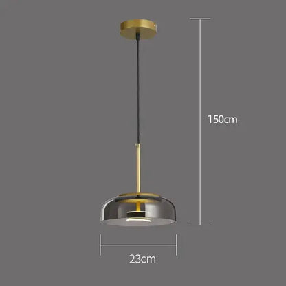 Modern tricolor glass pendant light with brass finish, smoked glass dome, and black cord for dining room use