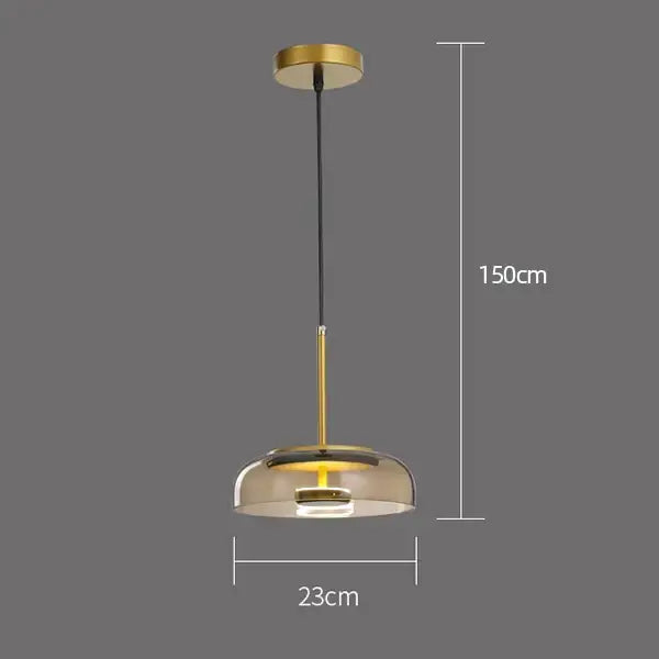 Modern tricolor glass pendant light with gold metal frame and smoked shade suspended by black cord for dining room