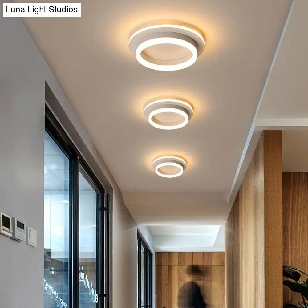 Three decorbites™ compact metal led flush mount ceiling lights with white acrylic diffuser and warm glow