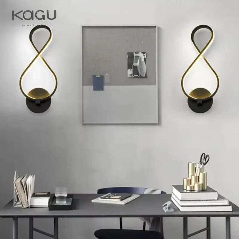 Gold infinity-shaped led wall lamps with black circular bases for modern bedroom lighting