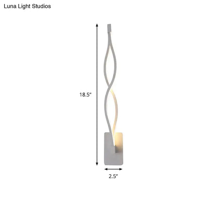 Modern twisted black and white led wall sconce with silver metal design providing warm ambient lighting for bedrooms