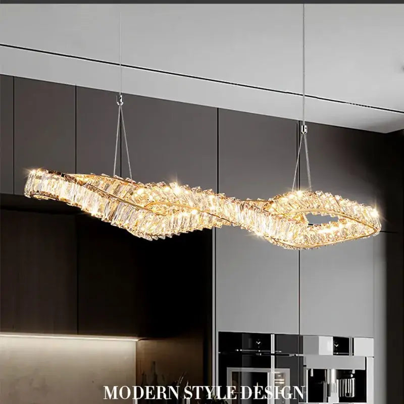 A modern twisted gold metal crystal pendant light with clear crystals and warm lighting for dining room decorbites gold metal