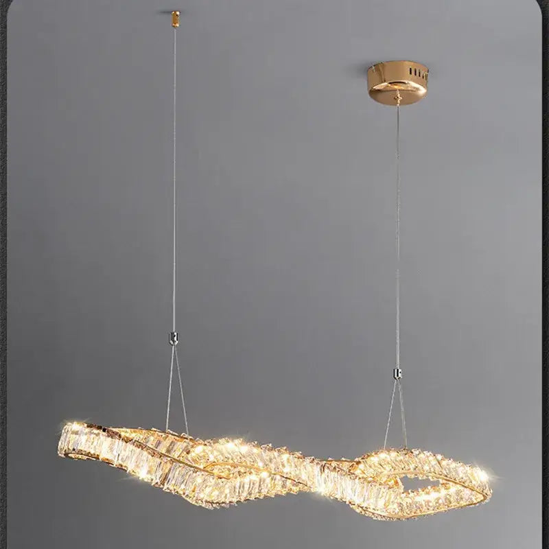 Modern twisted gold metal crystal pendant light with wavy design and clear crystals for dining room decorbites gold metal