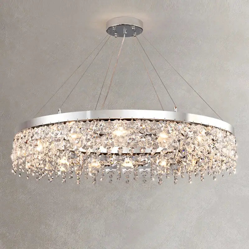 Modern two tier chrome decorbites crystal chandelier with cascading clear droplets illuminated by warm lights for living room