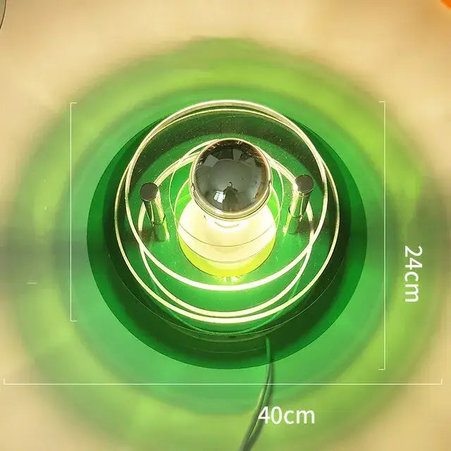Modern ufo acrylic led wall lamp featuring a green glass design with a central bulb and concentric circular rings for decorbites led wall decor