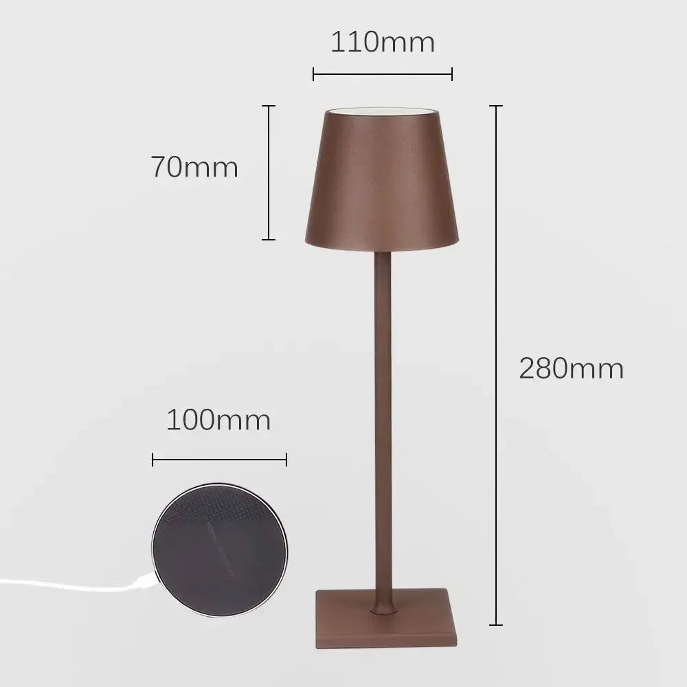 A sleek modern usb rechargeable acrylic table lamp with matte bronze finish and tapered shade for bedroom use