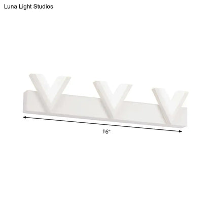 Modern 16-inch white wall-mounted vanity light with three stylized v-shaped warm white led lamps for bathroom mirror