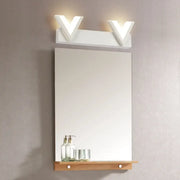 Modern v-shaped white led vanity light fixture with warm white illumination mounted above mirror and wooden shelf