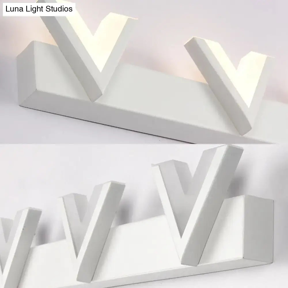 Modern white geometric v-shaped LED vanity light featuring warm white illumination for bathroom mirrors